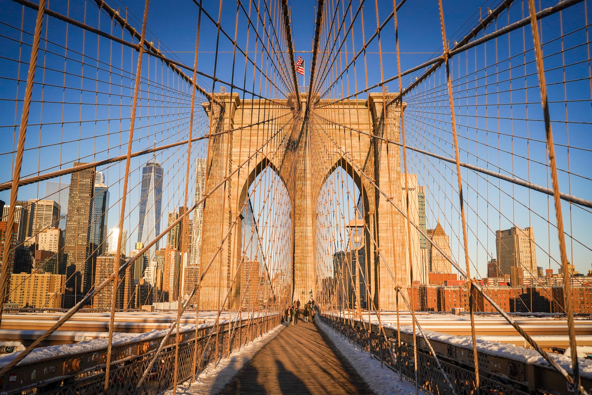 Brooklyn Bridge walkway with Manhattan skyline in winter light